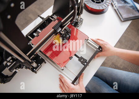 Top view of a 3d printer being in use Stock Photo