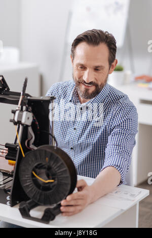 Delighted joyful man working in his office Stock Photo