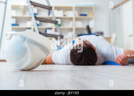 Worker after falling from height - unsafe behavior Stock Photo
