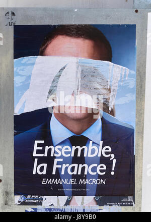 portrait of Emmanuel Macron in a election flyer vandalized and disfigured by vandals during french presidential election in France Stock Photo