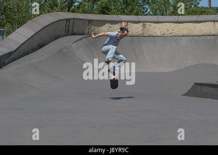 A skateboarder executing a kickflip in the air Stock Photo
