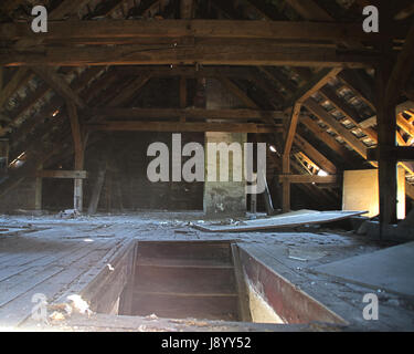 Stairs to the old forgotten garret with wooden roof. The forgotten attic. Stock Photo