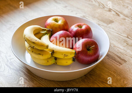 Red apples and bananas in fruit bowl close up  Model Release: No.  Property release: No. Stock Photo