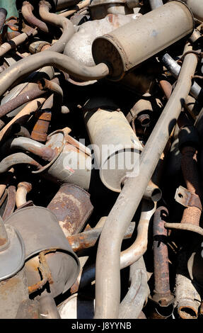 pile of old exhaust pipes on dump Stock Photo