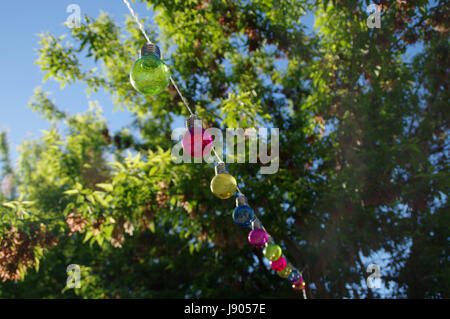 Colorful vitreous bulbs. Lamps on wire. Stock Photo