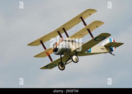 A replica Sopwith N500 triplane of the Great War Display Team performs at the Dunsfold airshow in Surrey, England on August 23, 2014. Stock Photo