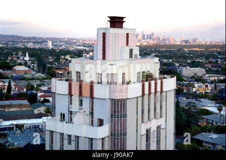 The upper floors and penthouse of the  art deco Sunset Tower Hotel on the Sunset Strip with a view of Downtown Los Angeles in the background.