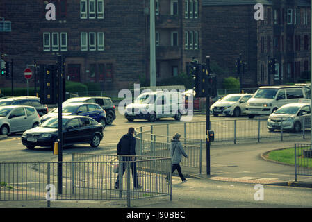 Anniesland cross Glasgow people crossing road at traffic lights at one of the busiest intersects in Europe Stock Photo