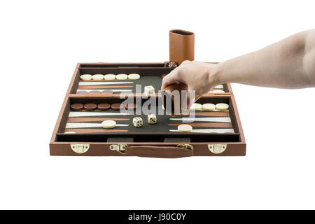 A woman's arm playing backgammon by throwing the die on the backgammon board with her righ hand. Isolated on a pure white background. Stock Photo