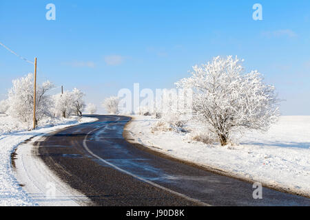 Picture of a country road on wintertime in sunlight Stock Photo