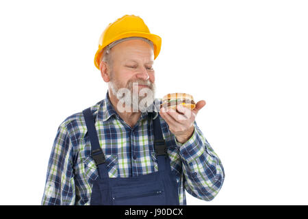Picture of a hungry mechanic having a lunch break, eating hamburger Stock Photo