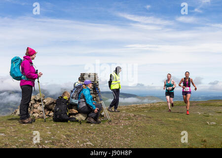 Walkers on the Summit of Clough Head Watching Runners Taking Part in the Helvellyn and the Dodds Fell Race, Lake District, Cumbria, UK. Stock Photo