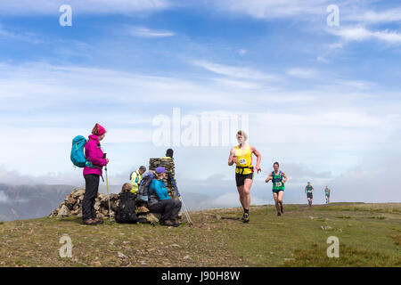Walkers on the Summit of Clough Head Watching Runners Taking Part in the Helvellyn and the Dodds Fell Race, Lake District, Cumbria, UK. Stock Photo