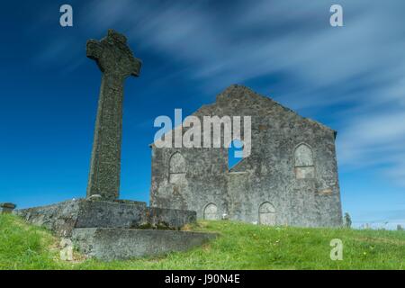 Edinburgh, UK. 30th May, 2017. Clouds rush over the Cross and Church at Kilchoman on the island of Islay. The cross dates back to the 1300's when the medieval church was built. The beautiful and very detailed Kilchoman Cross, carved in Iona style, measures 8 feet 4 inches in height, and with the exception of the inscription it is in a very perfect state of preservation, though the design is in places obscured by lichen. The cross has a striking similarity with the great cross at Oronsay Priory albeit that the Kilchoman Cross has more complicated scroll-work. Credit: Rich Dyson/Alamy Live News Stock Photo