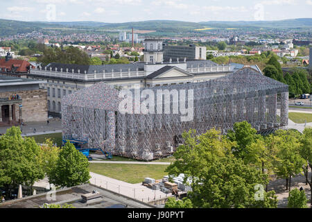 FILE - File picture dated 28 May 2017 showing books wrapped in plastic hanging from the scaffolding of the documenta art piece 'The Parthenon of Books' in Kassel, Germany. The imitation of the Greek Parthenon temple by the Argentinian artist Marta Minujin is one of the largest projects of documenta. The documenta 14 event in Kassel runs from 10 June to 17 September 2017. Photo: Swen Pförtner/dpa Stock Photo