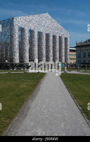 FILE - File picture dated 28 May 2017 showing books wrapped in plastic hanging from the scaffolding of the documenta art piece 'The Parthenon of Books' in Kassel, Germany. The imitation of the Greek Parthenon temple by the Argentinian artist Marta Minujin is one of the largest projects of documenta. The documenta 14 event in Kassel runs from 10 June to 17 September 2017. Photo: Swen Pförtner/dpa Stock Photo