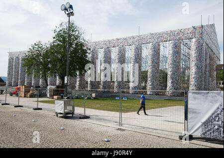 FILE - File picture dated 28 May 2017 showing books wrapped in plastic hanging from the scaffolding of the documenta art piece 'The Parthenon of Books' in Kassel, Germany. The imitation of the Greek Parthenon temple by the Argentinian artist Marta Minujin is one of the largest projects of documenta. The documenta 14 event in Kassel runs from 10 June to 17 September 2017. Photo: Swen Pförtner/dpa Stock Photo