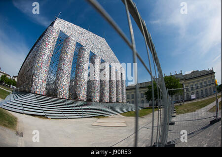 FILE - File picture dated 28 May 2017 showing books wrapped in plastic hanging from the scaffolding of the documenta art piece 'The Parthenon of Books' in Kassel, Germany. The imitation of the Greek Parthenon temple by the Argentinian artist Marta Minujin is one of the largest projects of documenta. The documenta 14 event in Kassel runs from 10 June to 17 September 2017. Photo: Swen Pförtner/dpa Stock Photo