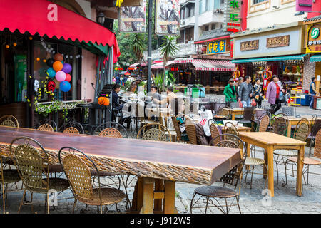 Guilin, China.  Outdoor restaurant Seating and Retail Shops on Pedestrian Shopping Street. Stock Photo