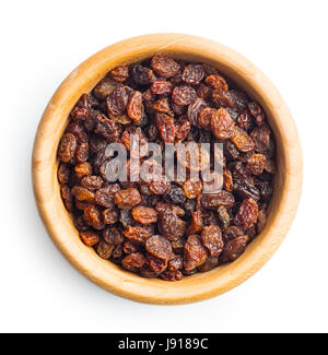 Sweet dried raisins in wooden bowl isolated on white background. Stock Photo