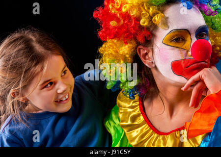 Single parent family. Mom after work birthday clown angry child. Stock Photo