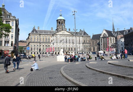 Panorama of crowded Dam square, central Amsterdam, Netherlands. 17th century Paleis op de Dam - Royal Palace of Amsterdam, on right Nieuwe Kerk church Stock Photo