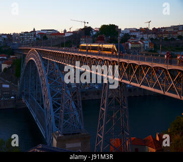 Ponte Dom Luís I during sunset, with yellow metro trams - Porto, Portugal Stock Photo