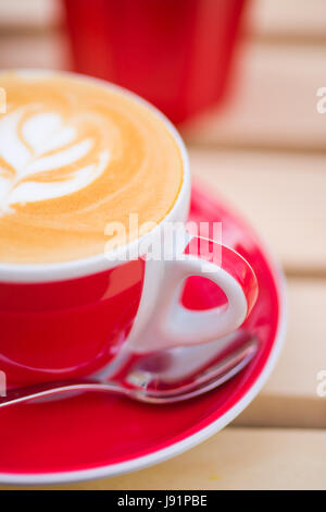 Close-up of cup of Cappuccino coffee with some cool design on the foam Stock Photo