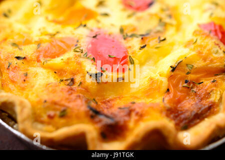 Home cooked mozzarella and char grilled peppers quiche in a foil tray Stock Photo