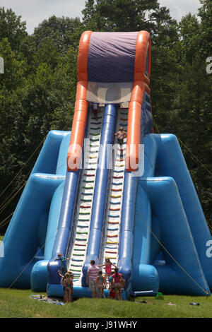 Children waiting in line to climb on huge water slide Stock Photo