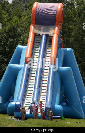 Children waiting in line to climb on huge water slide Stock Photo