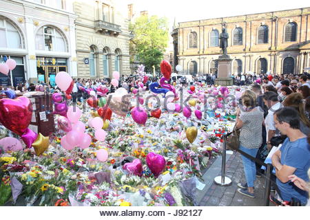 People pay tribute to the victims of the Manchester bombing in St Ann's Square at a memorial of flowers and other objects Credit: reallifephotos/Alamy Stock Photo