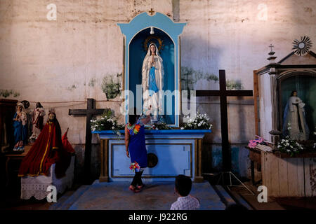 Young Filipino woman visiting the Roman Catholic San Isidro Labrador Parish Church commonly known as Lazi Church at the island of Siquijor located in the Central Visayas region of the Philippines Stock Photo