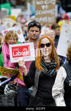Protesters and Corbyn supporters carrying signs and placards are pictured as they march through the streets of Bristol to protest about education cuts Stock Photo