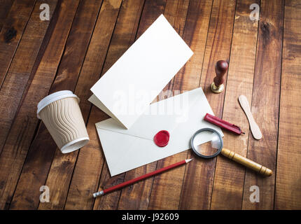 Blank stationery template on vintage wood table background. Vintage still life with postal accessories. Top view.