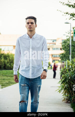 Attractive young man walking in city Stock Photo