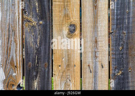 Horizontal weathered, multi-colored wooden fence background Stock Photo