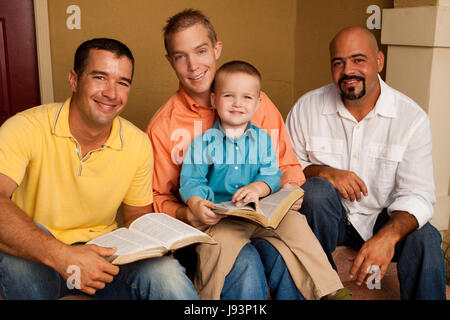 Men's Group Bible Study. Father reading the bible with his son. Stock Photo