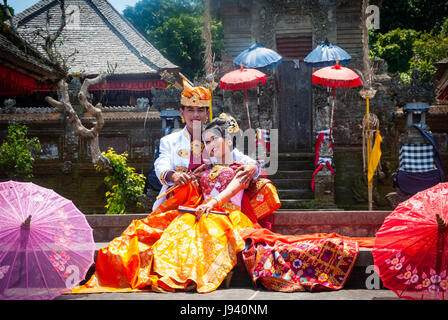 BALI, INDONESIA - SEPTEMBER 22: Indonesian just married couple dressed in traditional balinese clothing posing infront of the temple in Bali, Indonesi Stock Photo