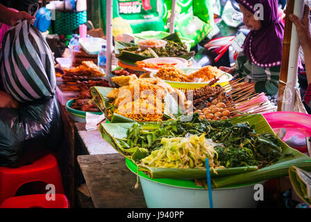 YOGYAKARTA, INDONESIA - SEPTEMBER 13: Woman selling traditional indonesian food on the food market in Yogyakarta, Indonesia on September 13, 2014. Stock Photo