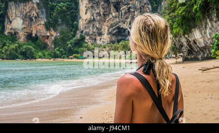 Blond beautiful Women with Sunglasses and Backpack on Raily, Hat Tom Sai Beach, Railay, Krabi Stock Photo