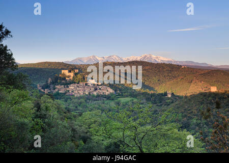 France, Pyrenees Orientales, Castelnou, labelled Les Plus Beaux Villages de France and the Snowy Canigou Peak in the morning far Stock Photo