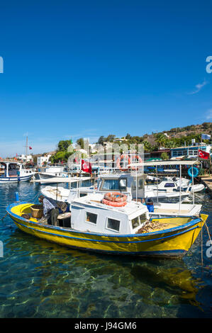 Scenic view of boats in the marina of a traditional Mediterranean fishing village in the seaside tourist village of Gumusluk, near Bodrum, Turkey Stock Photo