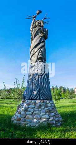 A wooden statue of the Russian fairytale character Baba Yaga in the form of a fake statue of Liberty. Stock Photo