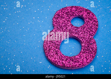 Number eight purple color over a blue background. Anniversary. Horizontal Stock Photo