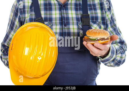 Close up picture of a male engineer holding his helmet and a tasty hamburger Stock Photo