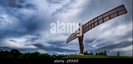 Gateshead, 5th June 2017. After basking in sunshine all weekend, Anthony Gormley's Angel of the North was greeted with rain and grey skies that pushed across the north of England. The statue's feet are currently covered in memorials for five local people killed in last month's terror attack in Manchester. (c) Credit: Paul Swinney/Alamy Live News Stock Photo