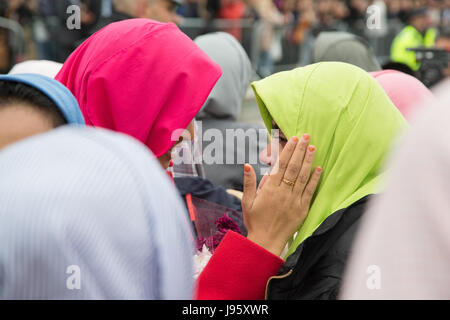 London, UK. 5th June, 2017. A Muslim Woman is comforted during a vigil in Potters Fields Park in London on June 5, 2017 to commemorate the victims of the terror attack on London Bridge and at Borough Market that killed seven people on June 3. Credit: Thabo Jaiyesimi/Alamy Live News Stock Photo