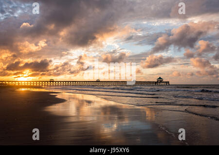 South Carolina, USA. 5th Jun, 2017. Dawn breaks over the Folly Beach Pier on a cloudy morning June 5, 2017 in Folly Beach, South Carolina. Folly Beach is a quirky beach community outside Charleston known to locals as the Edge of America. Credit: Planetpix/Alamy Live News