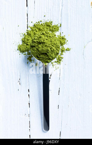 teaspoonful matcha tea on white wooden background Stock Photo